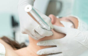 Med-spa skincare at Nayeli Integrative Health Clinic – technician using a handheld device to refine facial texture.